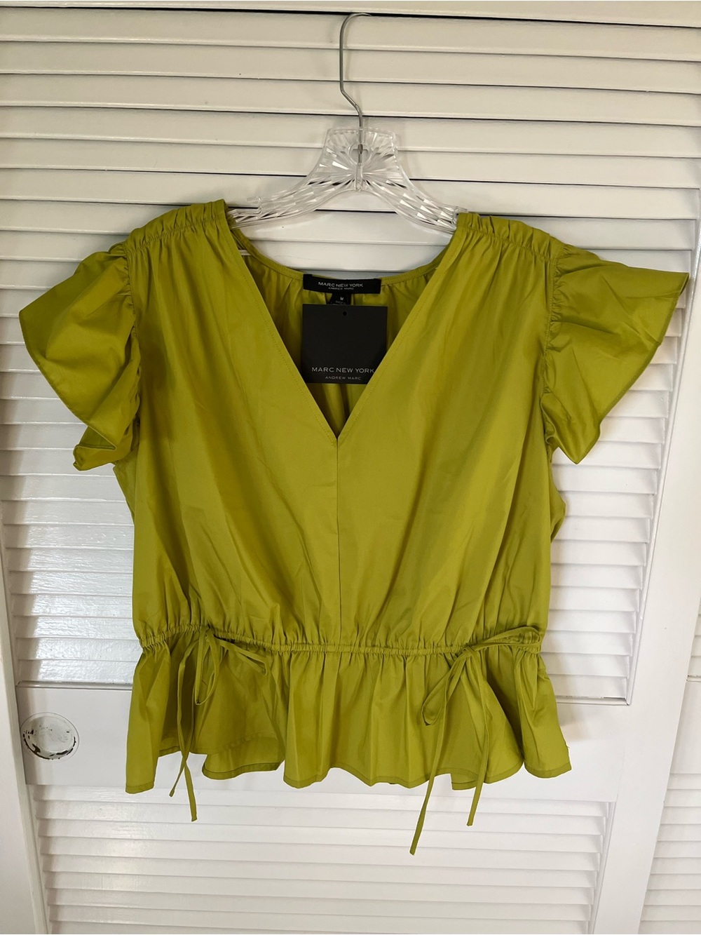 Marc New York Lime Green V-Neck Peplum Blouse mire like a shiny taffeta.